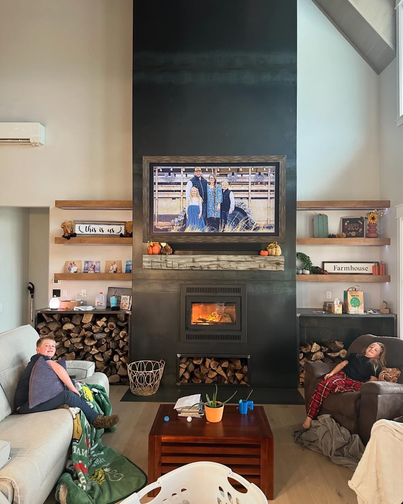 Living room with black floor-to-ceiling fireplace wall and built-in shelving at Cottonwood Creek