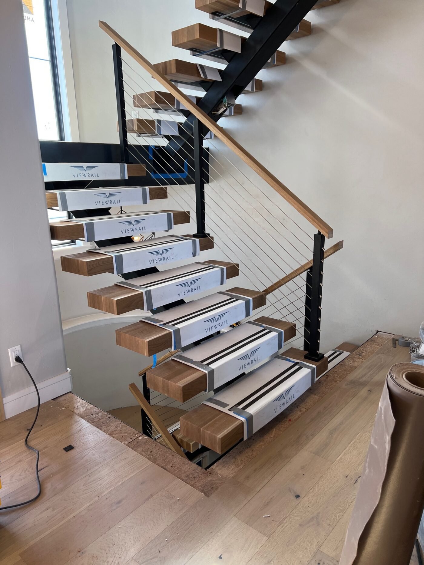 Floating wood staircase with cable railing at Cottonwood Creek