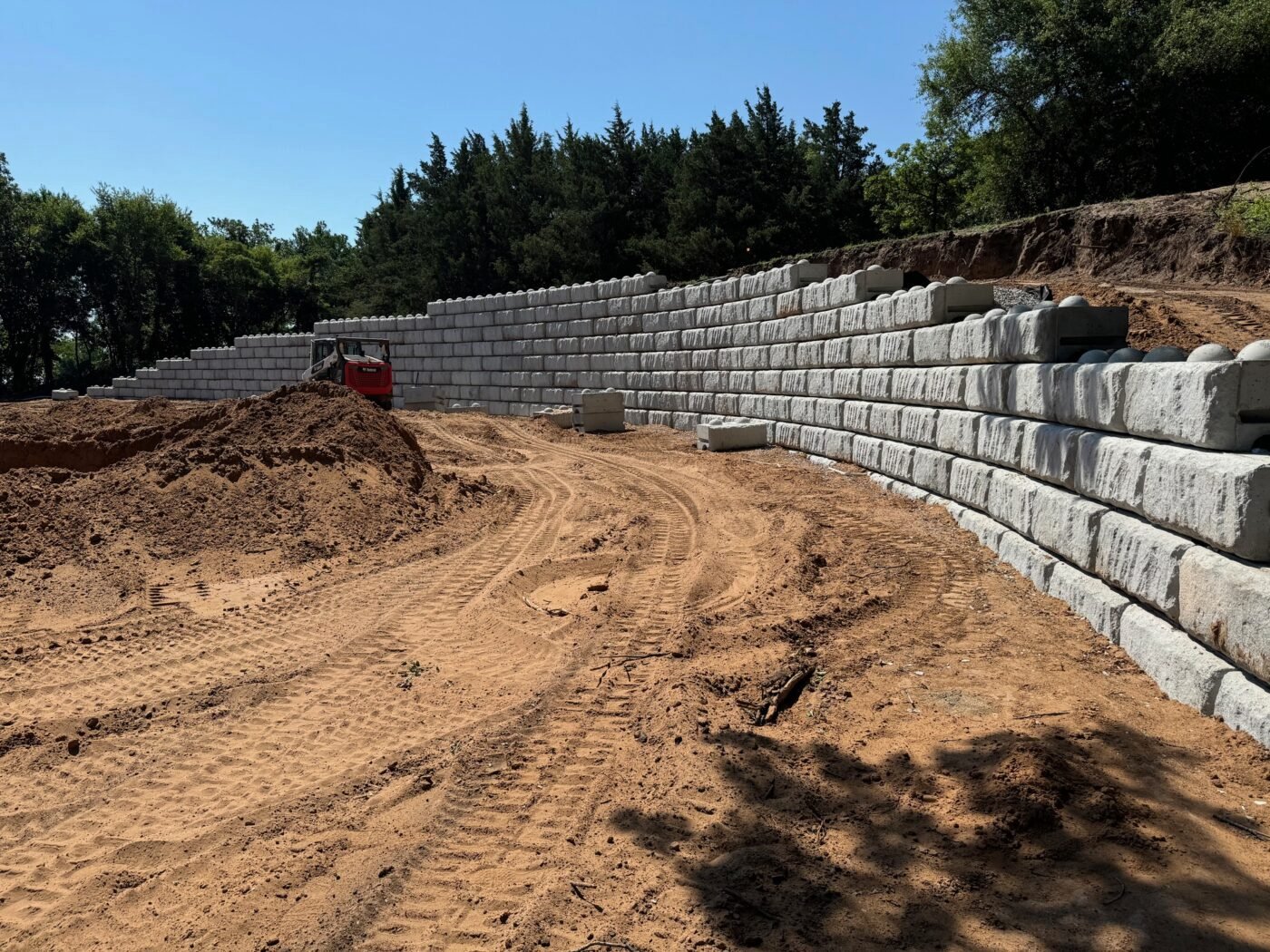 Large block retaining wall and graded site at Persimmon Creek