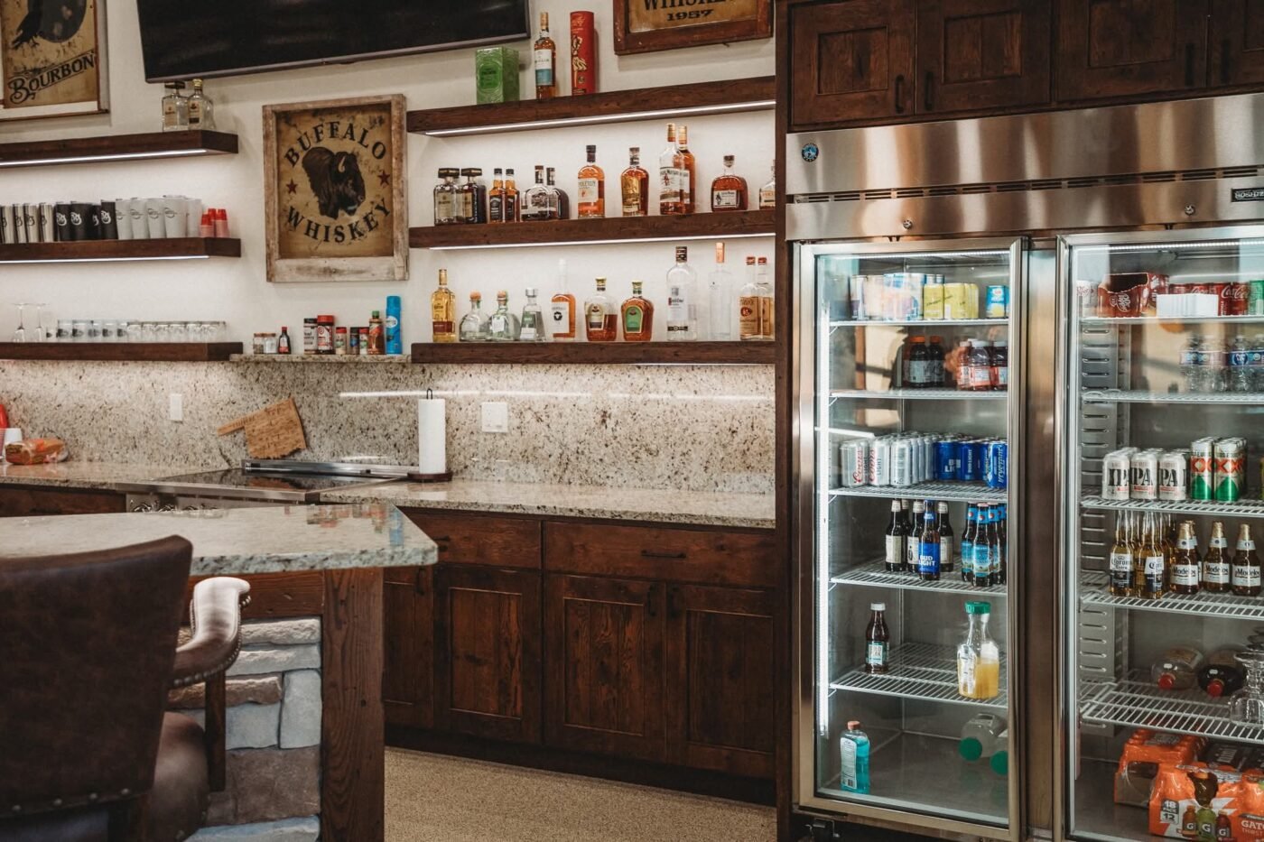 Persimmon Creek cabana bar with open shelving, stone backsplash and glass-door beverage fridge