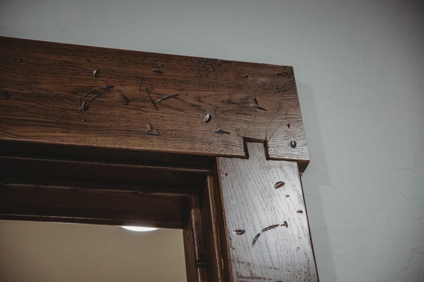 Close-up of rough-sawn wood trim with distressed edges
